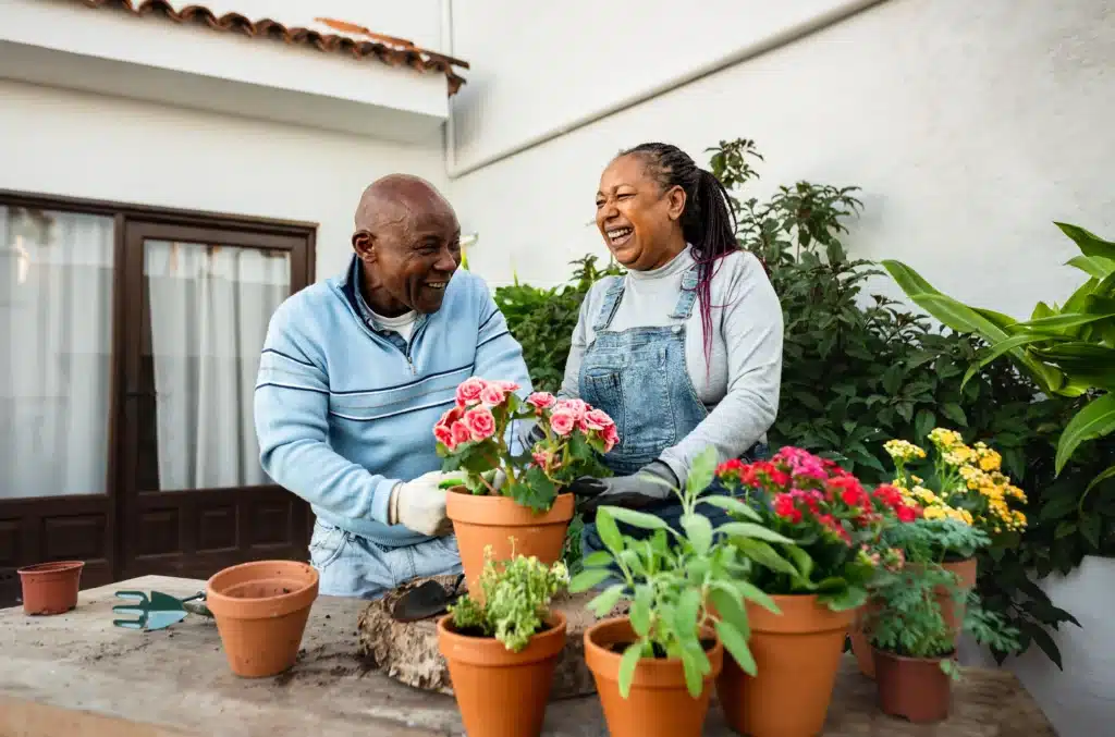 two smiling people gardening